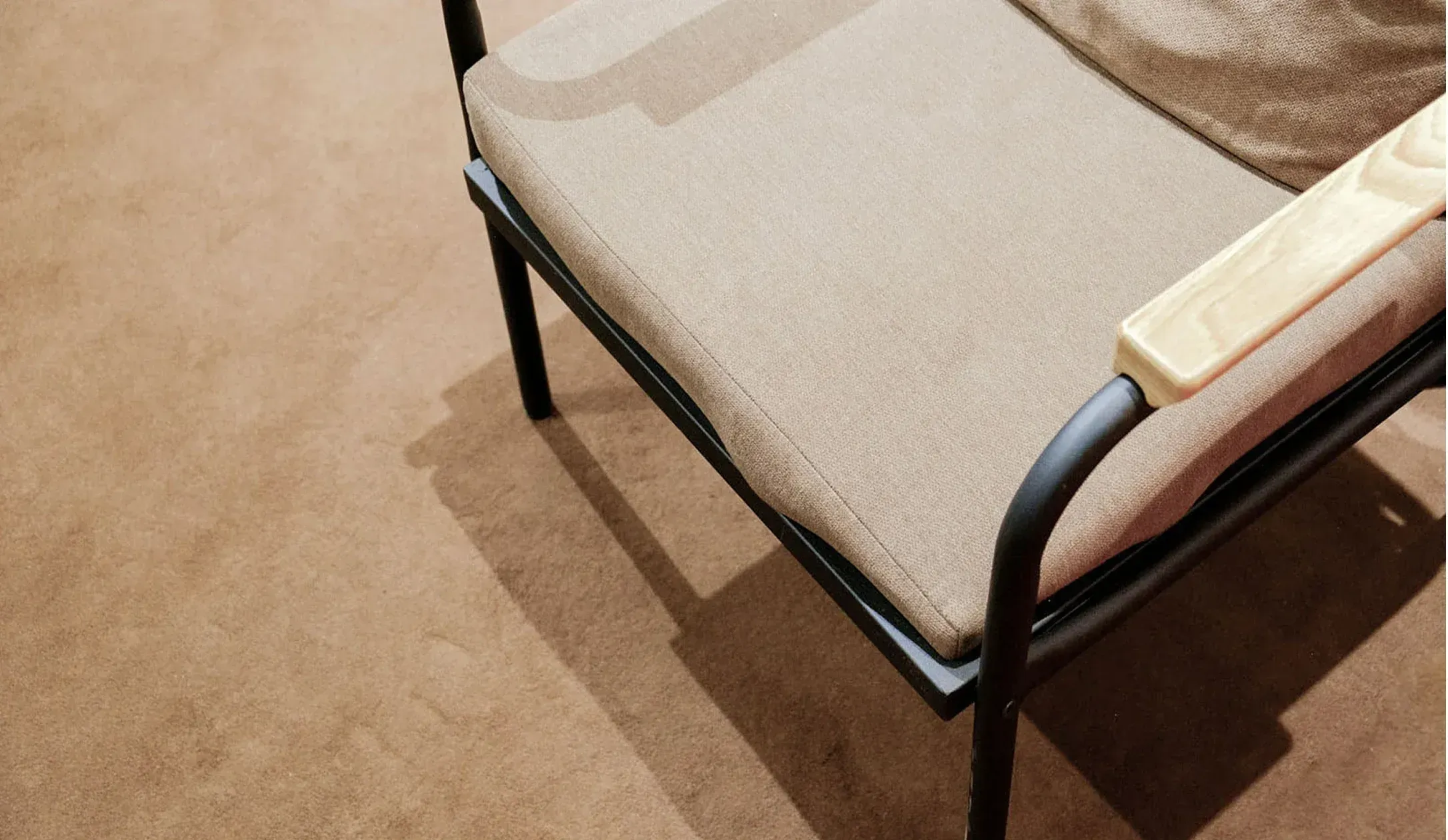Custom furniture design – Upholstered chair with black powder-coated frame.